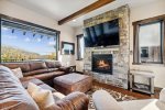 The spacious living area is the perfect place to enjoy the gas fireplace or TV